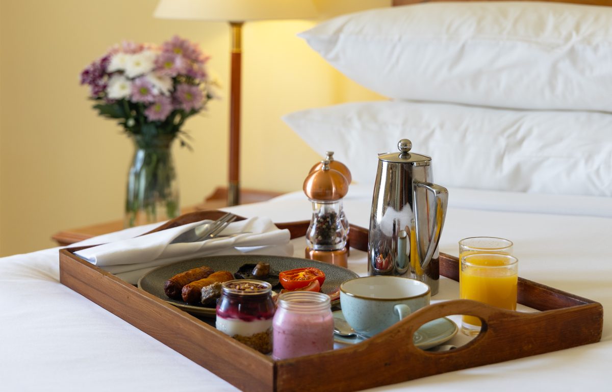 Room‑service breakfast tray placed on the bed in Galway Bay Hotel.